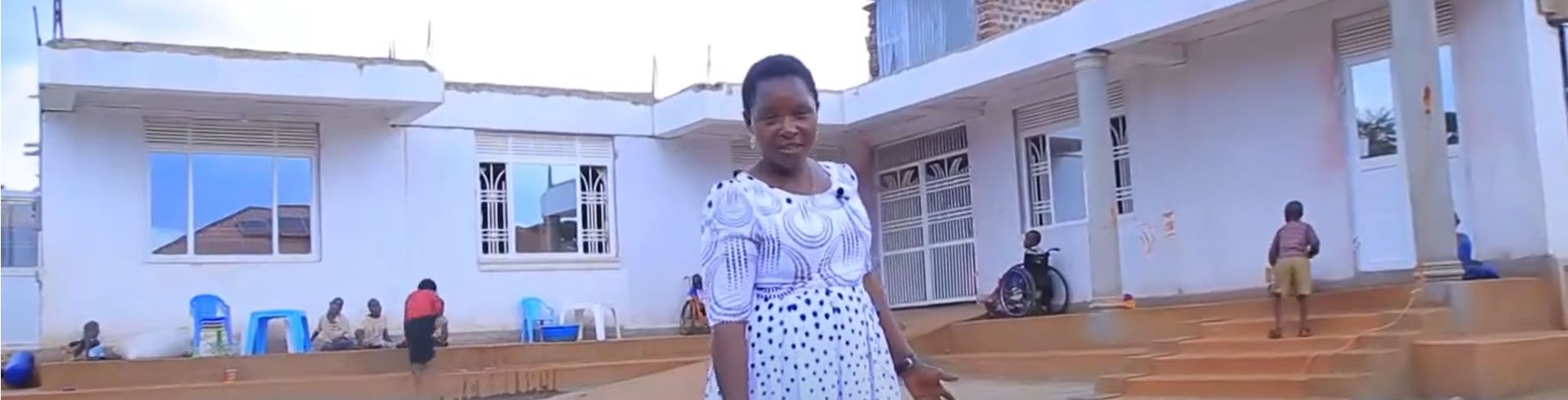 Edith standing in front of Home of Hope