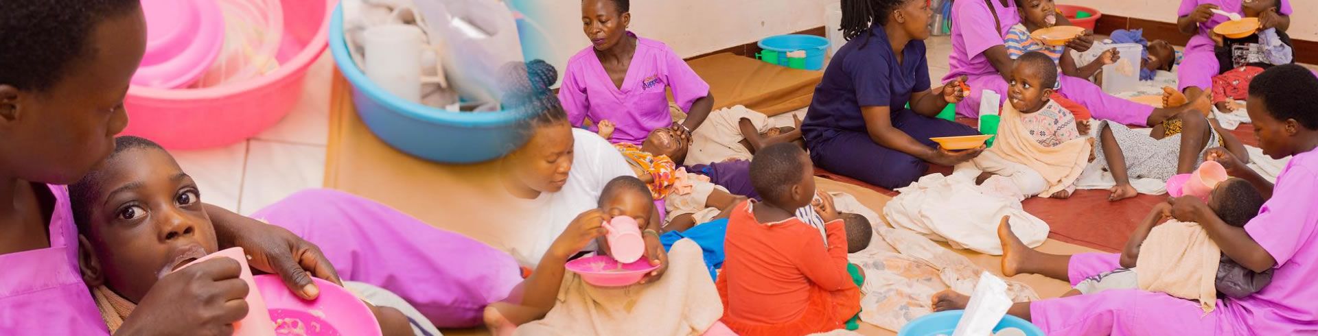 caretakers in pink scrubs with children